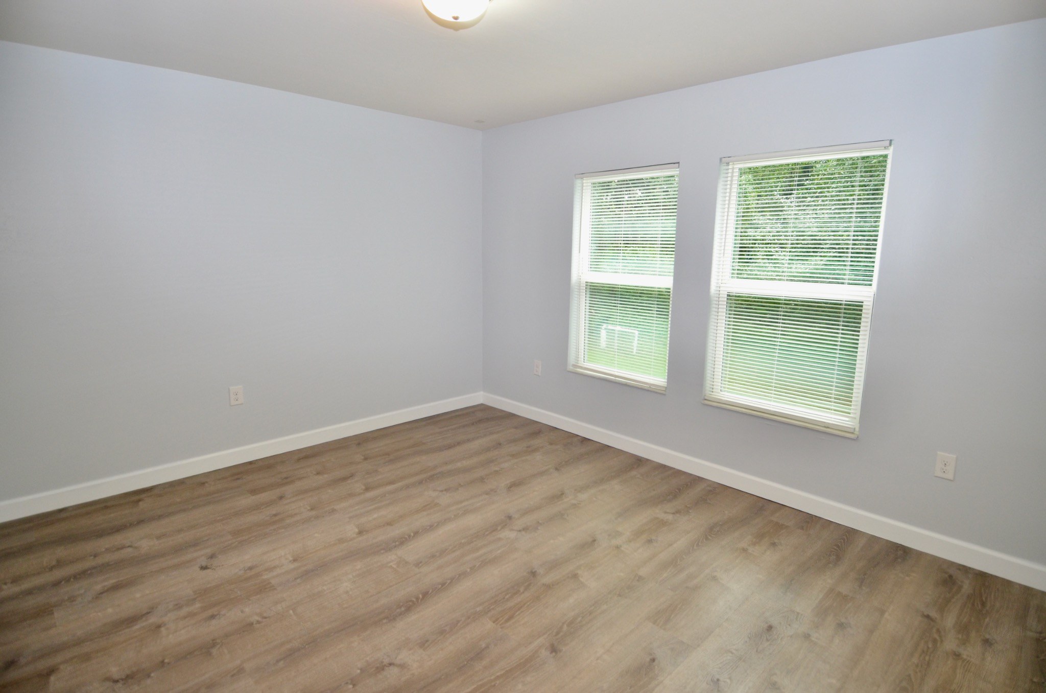 Primary bedroom with luxury vinyl flooring